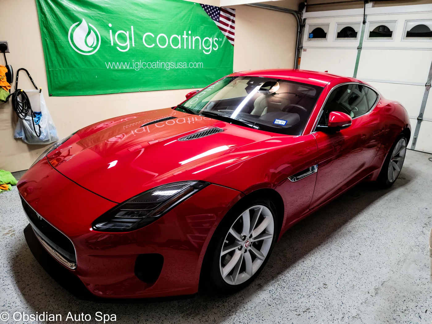 Red Jaguar coupe in the Obsidian Auto Spa garage
