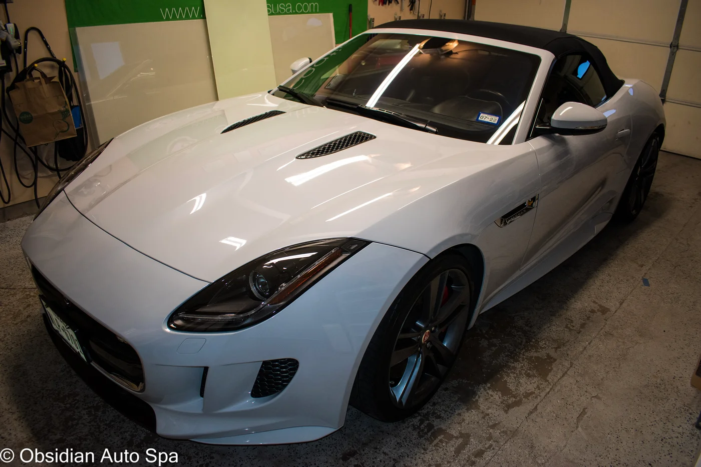 White Jaguar convertible in the garage